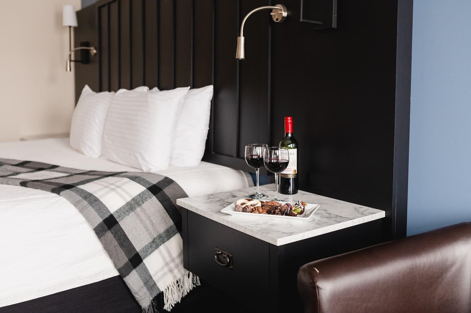 Our romantic hotel in Stillwater is also one of the best wedding venues in Minnesota, photo of a comfortable guest room with wine and treats