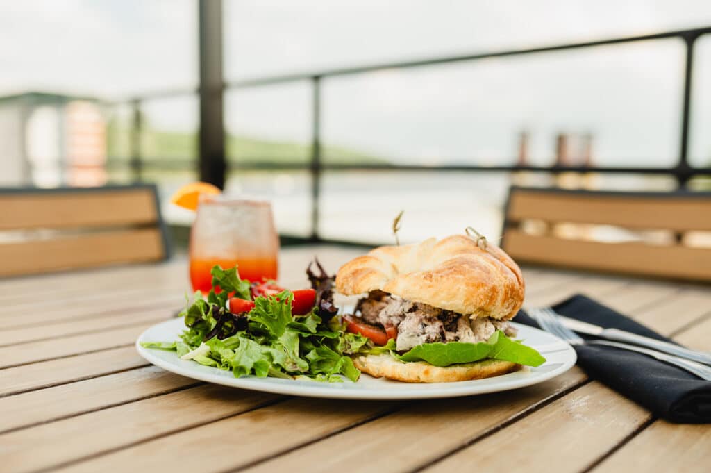 Enjoy a sandwich and aperol spritz at Papa's Rooftop, one of the best places to eat in Stillwater on the water.